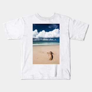 Beach driftwood and dark blue sky Kids T-Shirt